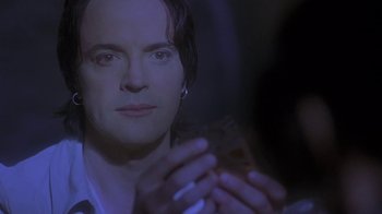 Movie still from “Hellraiser: Deader” (2005), directed by Rick Bota – A man holding a cell phone in his hands; Close Up shot, Over the shoulder angle