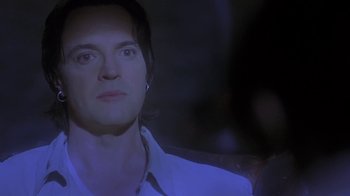 Movie still from “Hellraiser: Deader” (2005), directed by Rick Bota – A person wearing a white shirt; Close Up shot, Over the shoulder angle