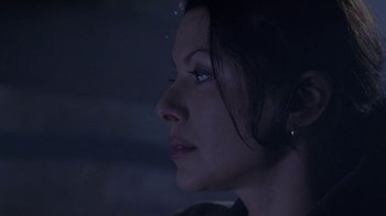 Movie still from “Hellraiser: Deader” (2005), directed by Rick Bota – A woman's face in the dark; Close Up shot, Over the shoulder angle