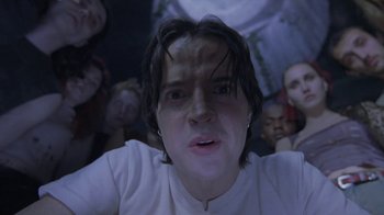 Movie still from “Hellraiser: Deader” (2005), directed by Rick Bota – A person with a bunch of people in the background; Close Up shot, Low angle