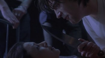 Movie still from “Hellraiser: Deader” (2005), directed by Rick Bota – A man and a woman face each other with a knife in their hands; Close Up shot, Over the shoulder angle