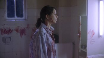 Movie still from “Hellraiser: Deader” (2005), directed by Rick Bota – A woman with blood all over her face and body; Medium shot, Over the shoulder angle