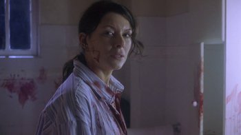Movie still from “Hellraiser: Deader” (2005), directed by Rick Bota – A woman with blood all over her face and neck; Close Up shot, Over the shoulder angle