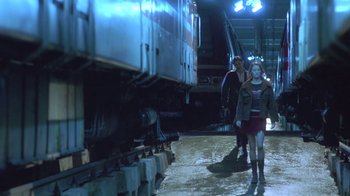 Movie still from “Hellraiser: Deader” (2005), directed by Rick Bota – A woman walking next to a train on a train track; Wide shot, Low angle