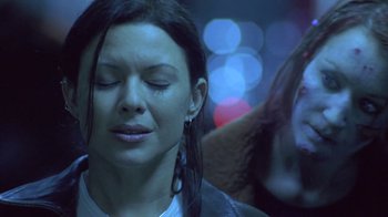 Movie still from “Hellraiser: Deader” (2005), directed by Rick Bota – A person with her eyes closed; Close Up shot, Over the shoulder angle