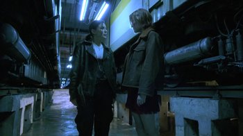 Movie still from “Hellraiser: Deader” (2005), directed by Rick Bota – Two people standing next to each other in a building; Medium shot, Low angle
