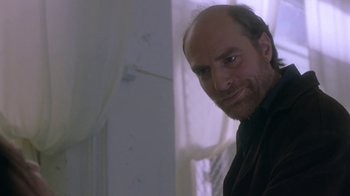 Movie still from “Hellraiser: Deader” (2005), directed by Rick Bota – A man with a goatee is smiling for the camera; Close Up shot, Low angle