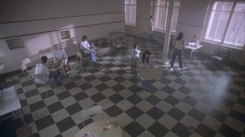 Movie still from “Hellraiser: Deader” (2005), directed by Rick Bota – A group of people sitting in a room with tables; Extreme Wide shot, High angle