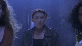 Movie still from “Hellraiser: Deader” (2005), directed by Rick Bota – A woman in a leather jacket standing in front of a wall; Close Up shot, Low angle