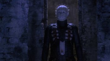 Movie still from “Hellraiser: Deader” (2005), directed by Rick Bota – A man in a suit with spikes on his head; Medium shot, Low angle