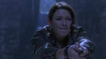 Movie still from “Hellraiser: Deader” (2005), directed by Rick Bota – A woman in a dark room holding her hands out; Close Up shot, Low angle
