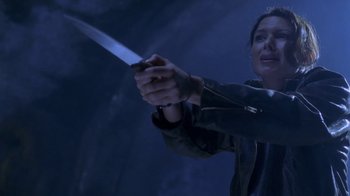 Movie still from “Hellraiser: Deader” (2005), directed by Rick Bota – A woman holding a knife in her hand; Close Up shot, Low angle