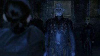 Movie still from “Hellraiser: Deader” (2005), directed by Rick Bota – A man in a suit with a skull and crossbones on his chest; Medium shot, Low angle