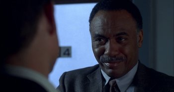 Movie still from “Hellraiser: Hellseeker” (2002), directed by Rick Bota – A man wearing a suit and tie talking to another man wearing a suit and tie; Close Up shot, Over the shoulder angle