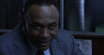 Movie still from “Hellraiser: Hellseeker” (2002), directed by Rick Bota – A person wearing a suit and tie; Close Up shot, Low angle