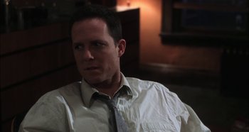 Movie still from “Hellraiser: Hellseeker” (2002), directed by Rick Bota – A person wearing a shirt and a tie; Close Up shot, Over the shoulder angle