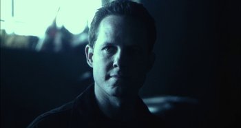 Movie still from “Hellraiser: Hellseeker” (2002), directed by Rick Bota – A person in a dark room; Close Up shot, Low angle