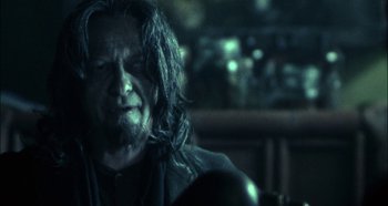 Movie still from “Hellraiser: Hellseeker” (2002), directed by Rick Bota – A man with long hair sitting in front of a mirror; Close Up shot, Over the shoulder angle