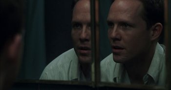 Movie still from “Hellraiser: Hellseeker” (2002), directed by Rick Bota – A man looking at his reflection in a mirror; Close Up shot, Over the shoulder angle