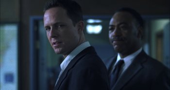 Movie still from “Hellraiser: Hellseeker” (2002), directed by Rick Bota – A man in a suit and tie standing next to another man in a suit and tie; Close Up shot, Low angle