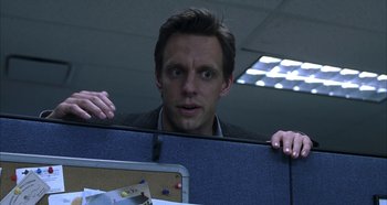 Movie still from “Hellraiser: Hellseeker” (2002), directed by Rick Bota – A man standing behind a cubicle door looking surprised; Close Up shot, Over the shoulder angle