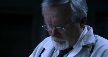 Movie still from “Hellraiser: Hellseeker” (2002), directed by Rick Bota – An older man in a white lab coat and tie; Close Up shot, Low angle