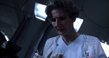 Movie still from “Hellraiser: Hellseeker” (2002), directed by Rick Bota – An older woman holding a knife in her hand; Close Up shot, Low angle