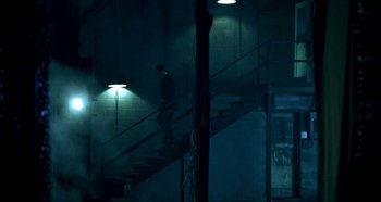 Movie still from “Hellraiser: Hellseeker” (2002), directed by Rick Bota – A man walking up a flight of stairs at night; Wide shot, Low angle