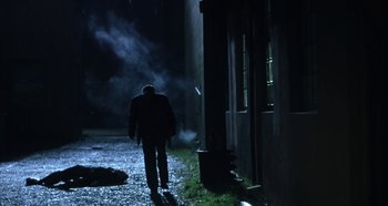 Movie still from “Hellraiser: Hellseeker” (2002), directed by Rick Bota – A man walking down a street at night; Wide shot, Low angle