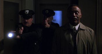 Movie still from “Hellraiser: Hellseeker” (2002), directed by Rick Bota – A group of police officers standing next to each other in the dark; Medium shot, Low angle