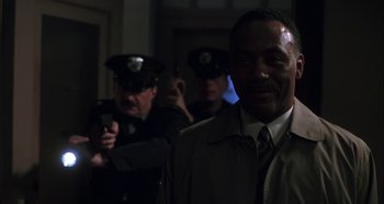 Movie still from “Hellraiser: Hellseeker” (2002), directed by Rick Bota – A group of police officers standing next to each other in a hallway; Close Up shot, Over the shoulder angle