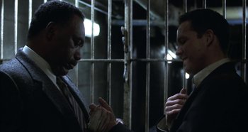 Movie still from “Hellraiser: Hellseeker” (2002), directed by Rick Bota – Two men in a jail cell talking to each other; Close Up shot, Low angle