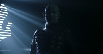Movie still from “Hellraiser: Hellseeker” (2002), directed by Rick Bota – A man in a body suit with a face like pinhead from hellraiser; Close Up shot, Low angle