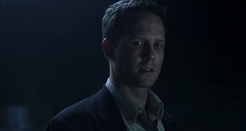 Movie still from “Hellraiser: Hellseeker” (2002), directed by Rick Bota – A person wearing a suit and tie; Close Up shot, Low angle