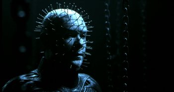 Movie still from “Hellraiser: Hellseeker” (2002), directed by Rick Bota – A man with a pinhead head in a dark room; Close Up shot, Low angle