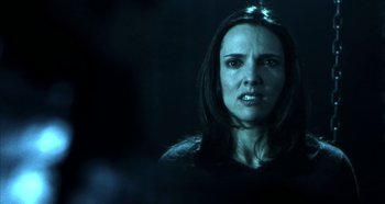 Movie still from “Hellraiser: Hellseeker” (2002), directed by Rick Bota – A woman in a black shirt is in the dark; Close Up shot, Low angle