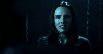 Movie still from “Hellraiser: Hellseeker” (2002), directed by Rick Bota – A woman with long hair is standing in the dark; Close Up shot, Low angle