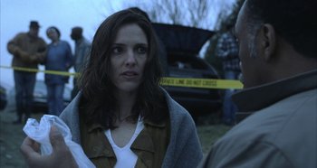 Movie still from “Hellraiser: Hellseeker” (2002), directed by Rick Bota – A woman standing next to a man in a field; Close Up shot, Over the shoulder angle