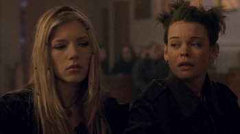 Movie still from “Hellraiser: Hellworld” (2005), directed by Rick Bota – Two women sitting next to each other in front of a crowd; Close Up shot, Over the shoulder angle