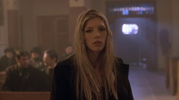 Movie still from “Hellraiser: Hellworld” (2005), directed by Rick Bota – A woman with long blonde hair standing in front of a crowd; Close Up shot, Low angle