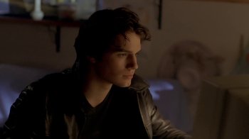 Movie still from “Hellraiser: Hellworld” (2005), directed by Rick Bota – A man in a leather jacket looking to his left; Close Up shot, Over the shoulder angle