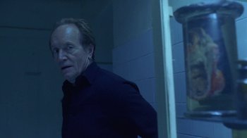 Movie still from “Hellraiser: Hellworld” (2005), directed by Rick Bota – An older man standing in front of a mirror; Medium shot, Low angle