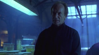 Movie still from “Hellraiser: Hellworld” (2005), directed by Rick Bota – An older man in a black shirt is looking at the camera; Close Up shot, Low angle