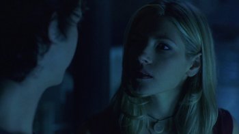 Movie still from “Hellraiser: Hellworld” (2005), directed by Rick Bota – A young woman stares into the distance while a young man looks at her; Close Up shot, Over the shoulder angle