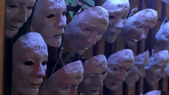 Movie still from “Hellraiser: Hellworld” (2005), directed by Rick Bota – A bunch of paper mache masks that have numbers on them; Close Up shot, High angle