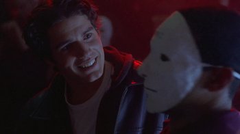 Movie still from “Hellraiser: Hellworld” (2005), directed by Rick Bota – A young man is looking at a white mask; Close Up shot, Over the shoulder angle