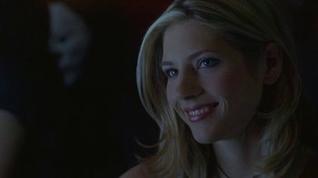 Movie still from “Hellraiser: Hellworld” (2005), directed by Rick Bota – A beautiful blonde woman with a smile on her face; Close Up shot, Over the shoulder angle