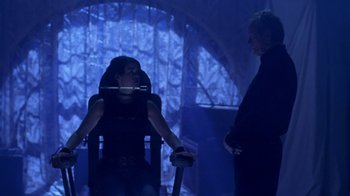 Movie still from “Hellraiser: Hellworld” (2005), directed by Rick Bota – A woman sitting in a chair next to another woman; Medium shot, Over the shoulder angle