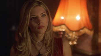 Movie still from “Hellraiser: Hellworld” (2005), directed by Rick Bota – A beautiful blonde woman wearing a red shirt; Close Up shot, Low angle
