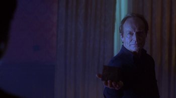 Movie still from “Hellraiser: Hellworld” (2005), directed by Rick Bota – An older man holding something in his hand; Medium shot, Low angle